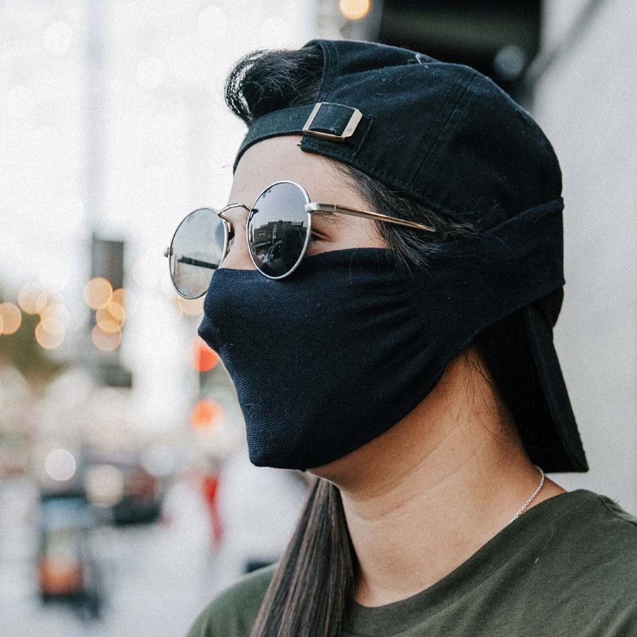 30X Mask, black neck loop mask, being worn in the city