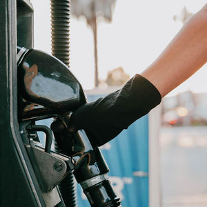 30X SafeSleeve Hand Protector, black antimicrobial hand covering, being used at a gas pump - Added protection for shared surfaces